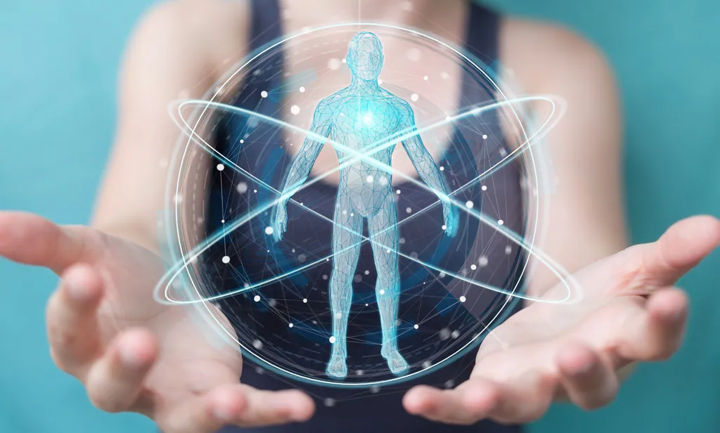 Hands holding a glowing human figure representing biofrequency energy